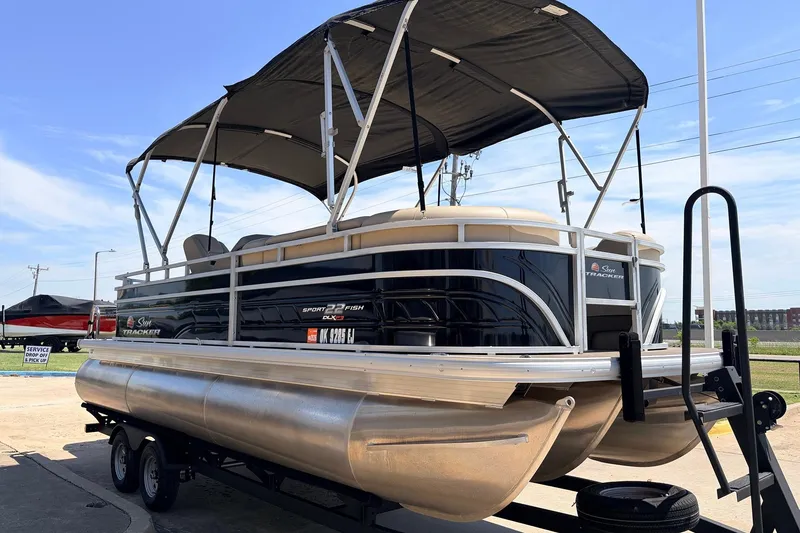 Slide: The Image of 2024 Sun Tracker SportFish 22 XP3 pontoon boat with canopy on trailer. - 3
