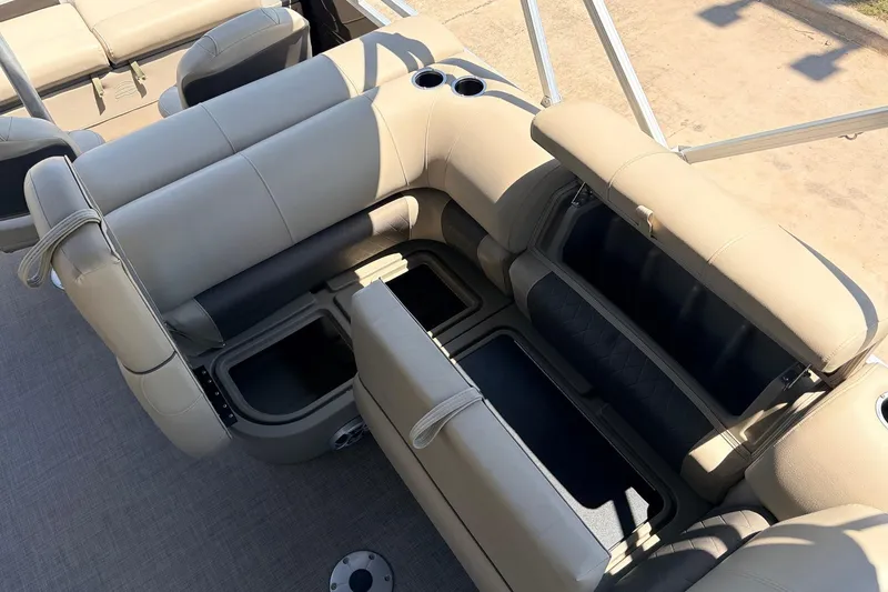 Slide: The Image of 2024 Sun Tracker SportFish 22 XP3 boat interior with beige seating and storage compartments. - 31