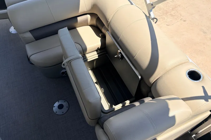 Slide: The Image of 2024 Sun Tracker SportFish 22 XP3 boat interior with beige seating and storage compartment. - 32
