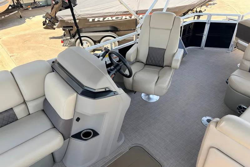 Slide: The Image of 2024 Sun Tracker SportFish 22 XP3 interior with plush seating and modern helm design. - 33