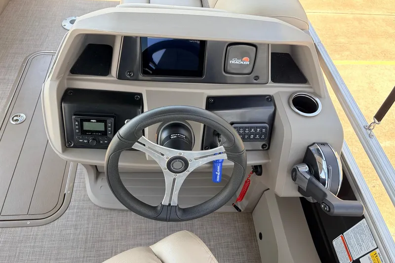 Slide: The Image of 2024 Sun Tracker SportFish 22 XP3 boat dashboard with steering wheel and controls. - 35