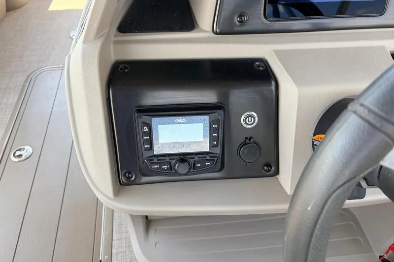Slide: The Image of Dashboard of 2024 Sun Tracker SportFish 22 XP3 with control panel and steering wheel. - 36