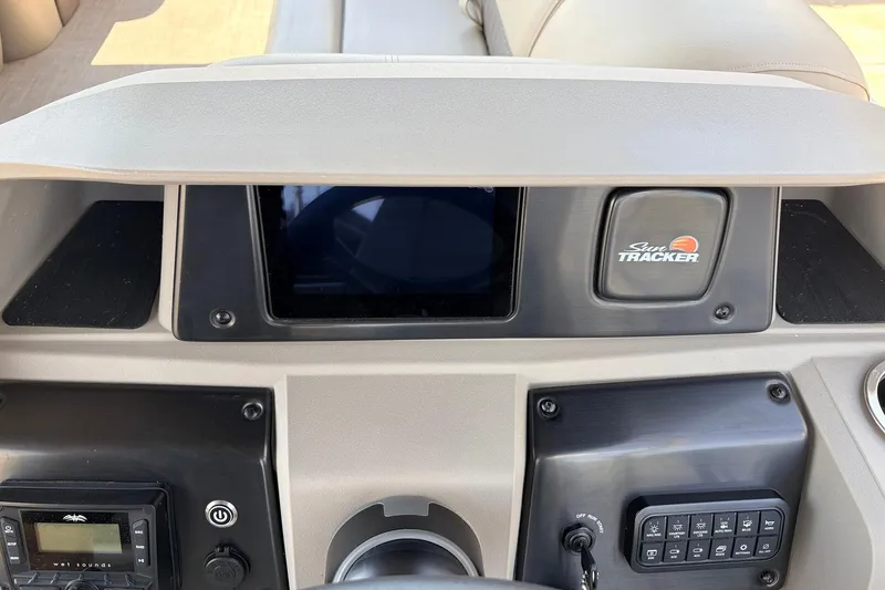 Slide: The Image of 2024 Sun Tracker SportFish 22 XP3 dashboard with controls and Sun Tracker logo. - 37