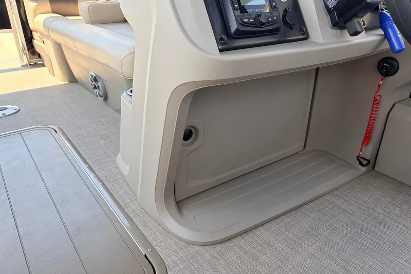 Slide: The Image of 2024 Sun Tracker SportFish 22 XP3 interior with beige seating and control panel. - 39