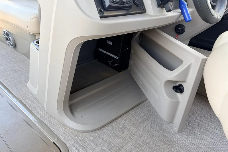 Slide: The Image of 2024 Sun Tracker SportFish 22 XP3 storage compartment with open door, showcasing interior space. - 40