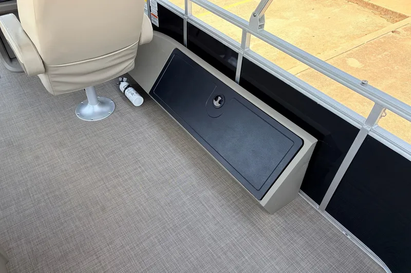 Slide: The Image of 2024 Sun Tracker SportFish 22 XP3 interior with beige seating and storage compartment. - 43