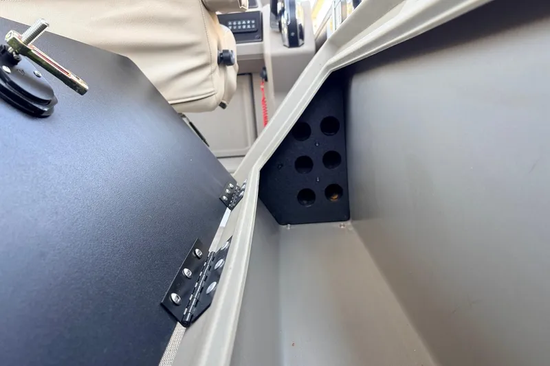 Slide: The Image of 2024 Sun Tracker SportFish 22 XP3 interior storage compartment with hinged door and seating. - 44