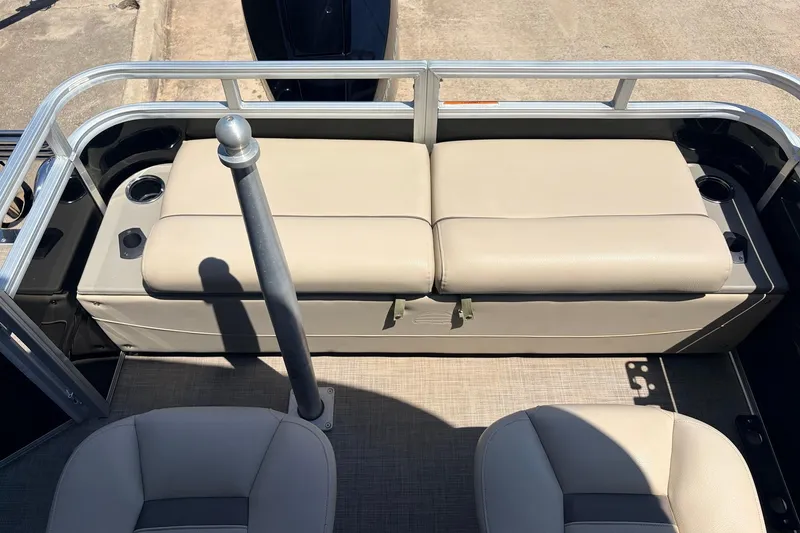 Slide: The Image of 2024 Sun Tracker SportFish 22 XP3 boat interior with beige seating and cup holders. - 46