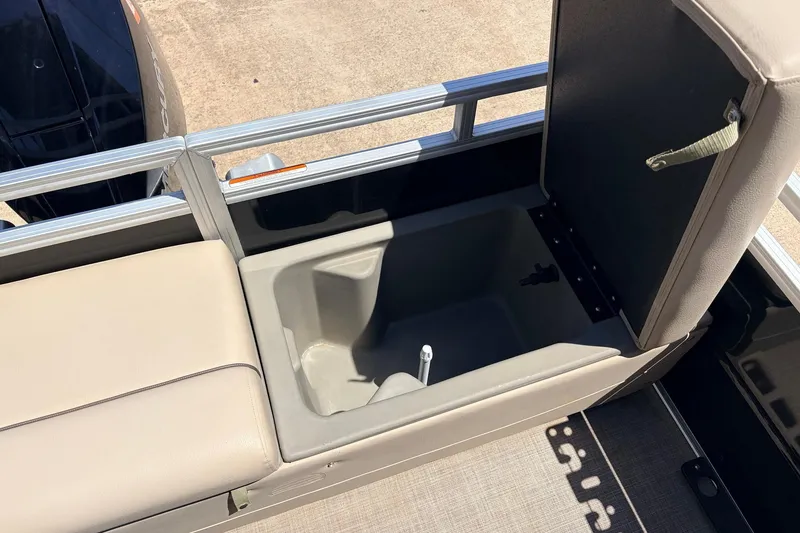 Slide: The Image of 2024 Sun Tracker SportFish 22 XP3 boat storage compartment with open lid, showcasing interior space. - 47
