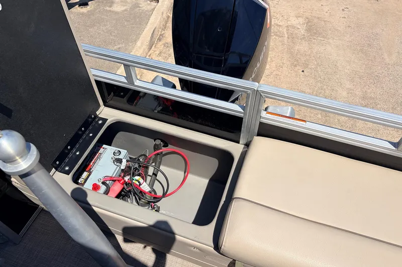 Slide: The Image of 2024 Sun Tracker SportFish 22 XP3 boat battery compartment with wiring and seating. - 48