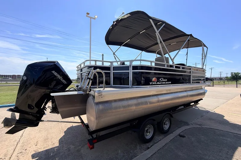 Slide: The Image of 2024 Sun Tracker SportFish 22 XP3 pontoon boat with Mercury outboard engine on trailer. - 5