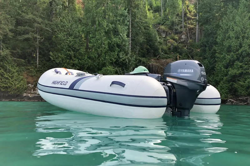 The Image of 2026 Highfield UltraLite 290 inflatable boat with Yamaha motor on serene water. - 0