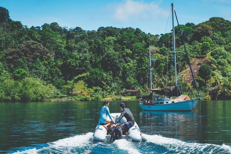 Slide: The Image of Manufacturer Provided Image: Highfield UltraLite 290 boat cruising on a serene lake with lush forest backdrop, 2025 model. - 5