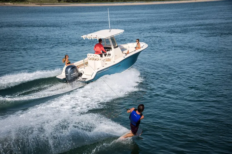 Slide: The Image of 2027 Grady-White Fisherman 216 boat towing a wakeboarder on a sunny day. - 2