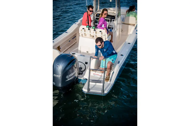 Slide: The Image of 2027 Grady-White Fisherman 216 boat with Yamaha engine, people enjoying water activities. - 4