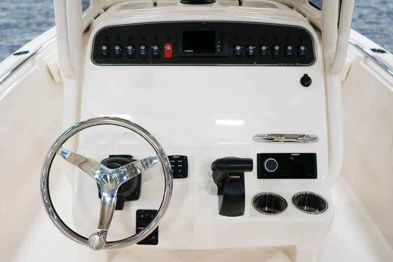 Slide: The Image of 2027 Grady-White Fisherman 216 boat dashboard with steering wheel and controls. - 7