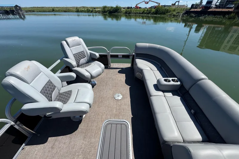 Slide: The Image of Luxurious seating on 2022 Ranger 223FC boat, docked by calm waters. - 10