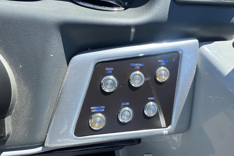 Slide: The Image of Control panel of a 2022 Ranger 223FC boat with various function buttons. - 18