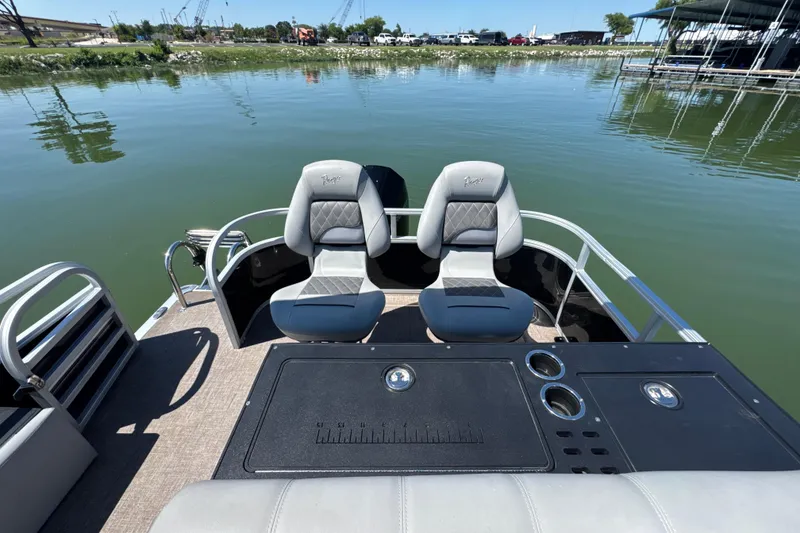 Slide: The Image of 2022 Ranger 223FC boat with dual seats on a calm lake. - 20