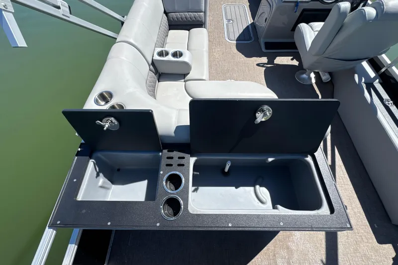 Slide: The Image of 2022 Ranger 223FC boat interior with seating, cup holders, and storage compartments. - 21