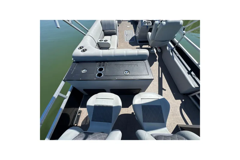 Slide: The Image of 2022 Ranger 223FC boat interior with seating and console on calm water. - 22