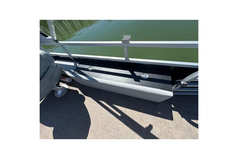 Slide: The Image of 2022 Ranger 223FC boat interior with seating and railing, on calm water. - 23