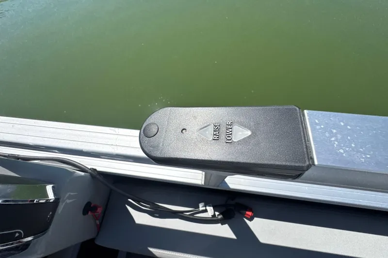 Slide: The Image of Control panel on a 2022 Ranger 223FC boat, featuring raise and lower buttons. - 25