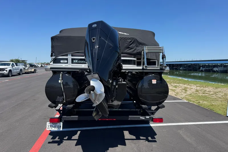 Slide: The Image of 2022 Ranger 223FC boat on trailer, parked near marina under clear blue sky. - 7