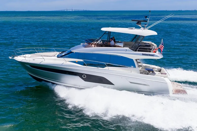 The Image of Luxury 2022 Prestige 520 yacht cruising on open blue waters. - 0