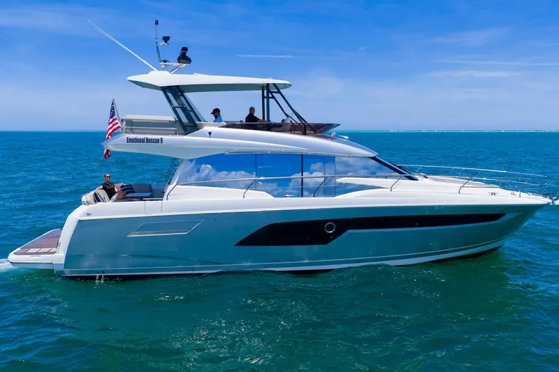 Slide: The Image of 2022 Prestige 520 yacht cruising on open sea under clear blue sky. - 100