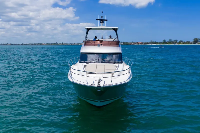 Slide: The Image of 2022 Prestige 520 yacht cruising on clear blue waters under a sunny sky. - 102