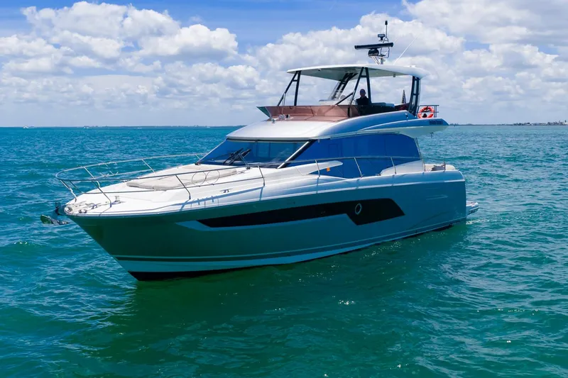 Slide: The Image of Luxury 2022 Prestige 520 yacht cruising on clear blue ocean waters. - 103
