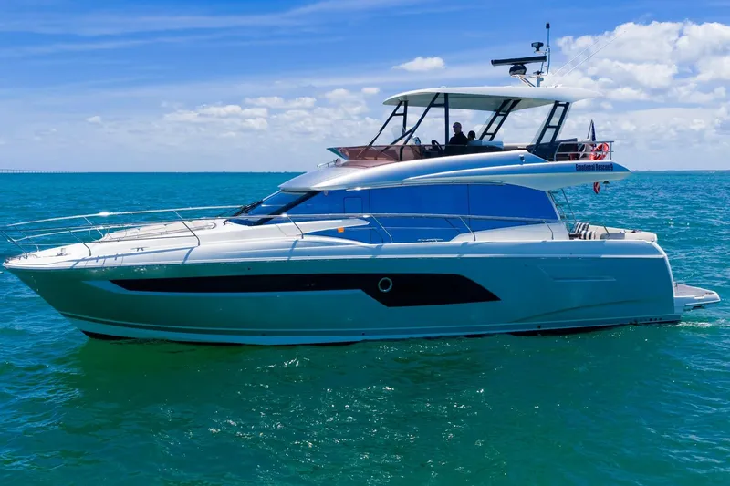 Slide: The Image of 2022 Prestige 520 yacht cruising on clear blue ocean under sunny skies. - 104