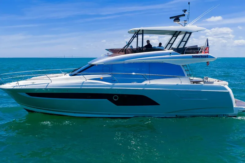 Slide: The Image of 2022 Prestige 520 yacht cruising on clear blue ocean waters. - 105