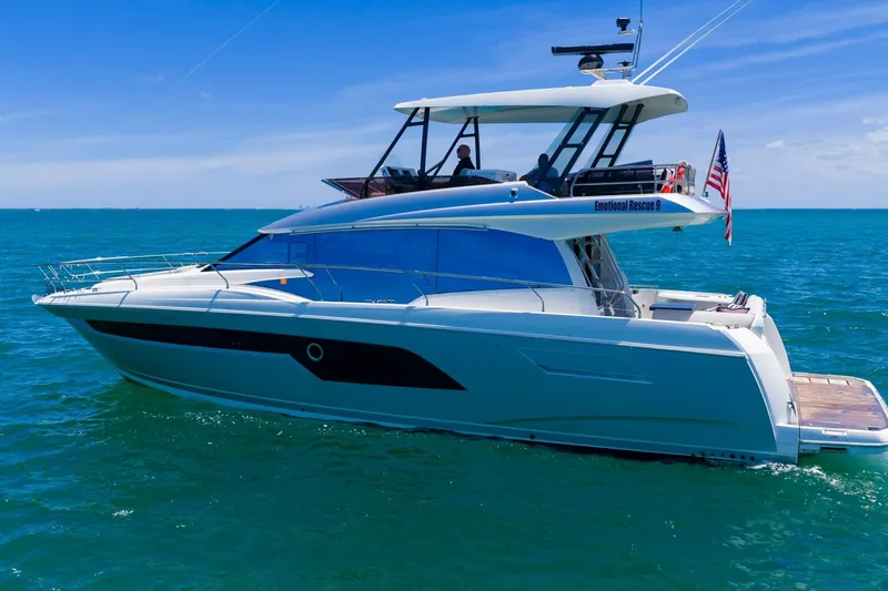 Slide: The Image of 2022 Prestige 520 yacht cruising on clear blue ocean under sunny skies. - 106