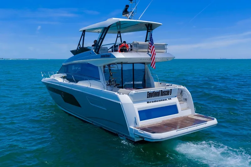 Slide: The Image of Luxury 2022 Prestige 520 yacht cruising in clear blue ocean waters. - 107