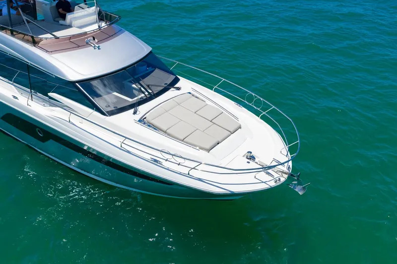 Slide: The Image of Luxury 2022 Prestige 520 yacht cruising on clear blue water. - 110