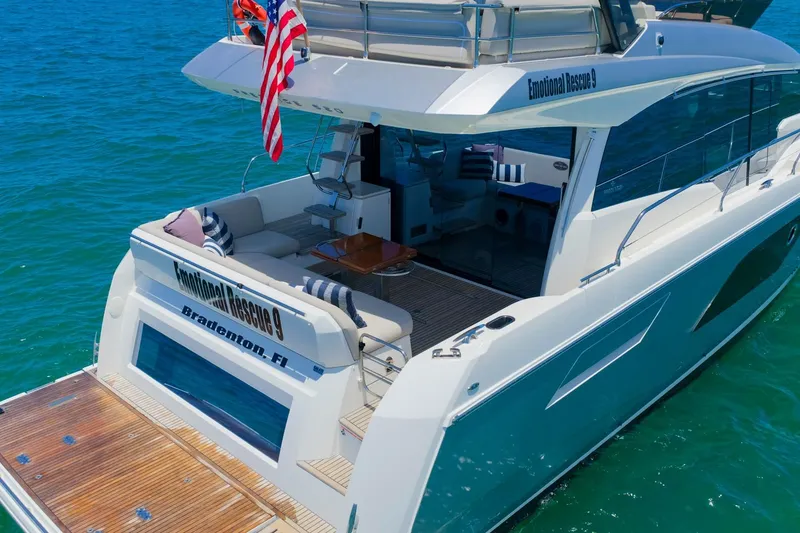 Slide: The Image of Luxury 2022 Prestige 520 yacht on clear blue water, featuring spacious deck and elegant design. - 113