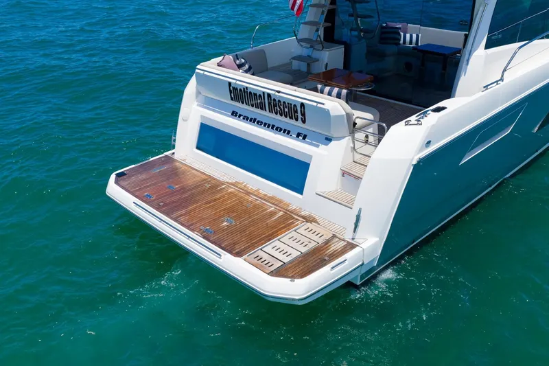 Slide: The Image of 2022 Prestige 520 yacht on water, featuring spacious deck and elegant design. - 114