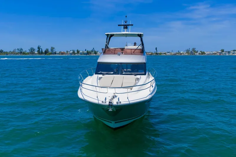 Slide: The Image of 2022 Prestige 520 yacht cruising on clear blue waters under a sunny sky. - 115