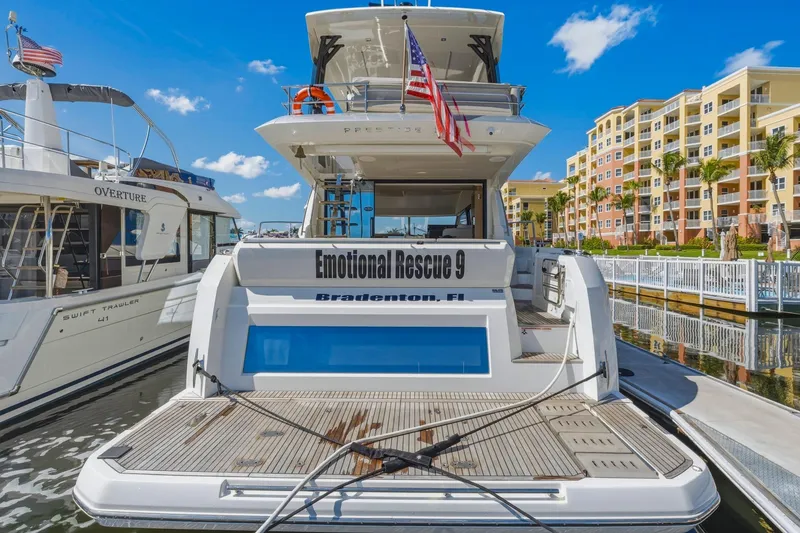 Slide: The Image of Luxury Prestige 520 yacht docked, featuring "Emotional Rescue 9" in Bradenton, Florida, 2022 model. - 12