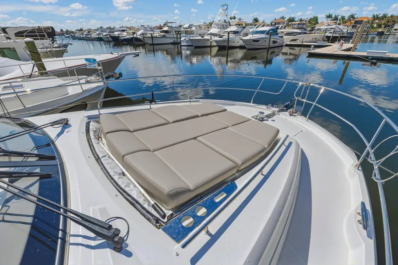 Slide: The Image of Prestige 520 yacht, 2022 model, docked with sunbathing cushions on deck. - 13