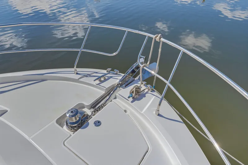 Slide: The Image of Bow of 2022 Prestige 520 yacht with anchor and railing on calm water. - 14