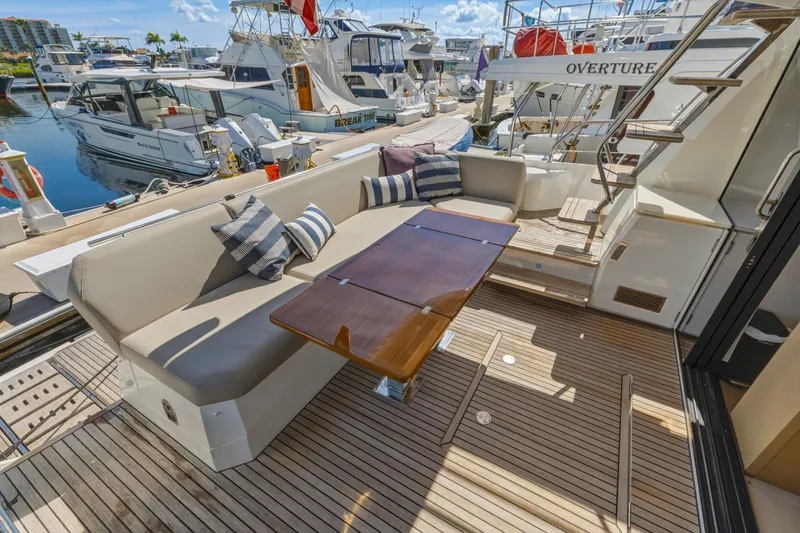 Slide: The Image of Luxurious 2022 Prestige 520 yacht deck with seating and table, docked at marina. - 17