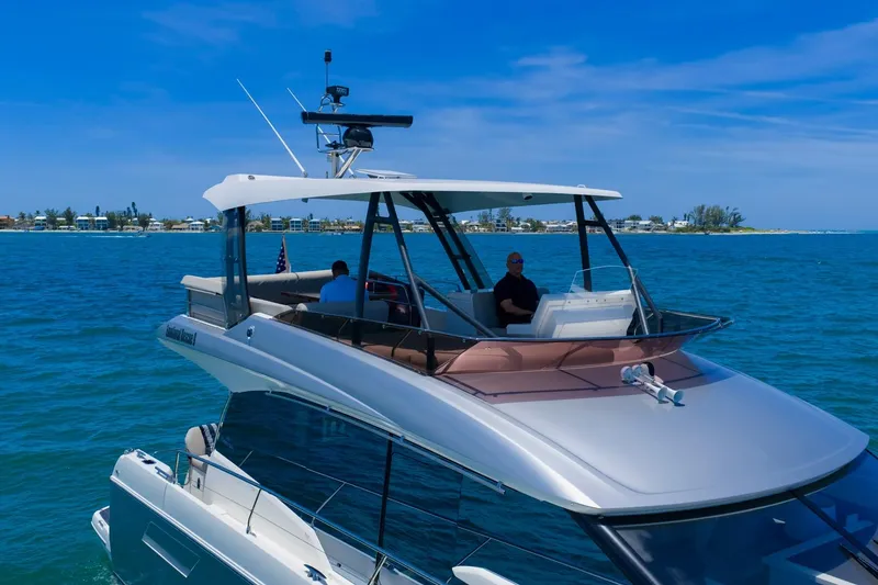 Slide: The Image of Luxury 2022 Prestige 520 yacht cruising on clear blue waters under a sunny sky. - 2