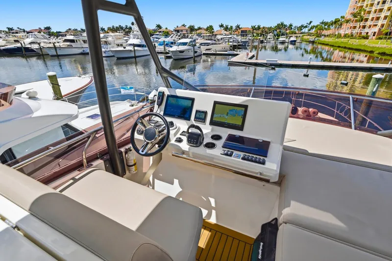 Slide: The Image of Cockpit view of 2022 Prestige 520 yacht at marina, featuring modern navigation equipment. - 21