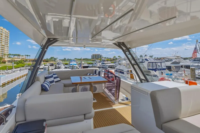 Slide: The Image of Luxurious 2022 Prestige 520 yacht interior with marina view, featuring elegant seating and table. - 24