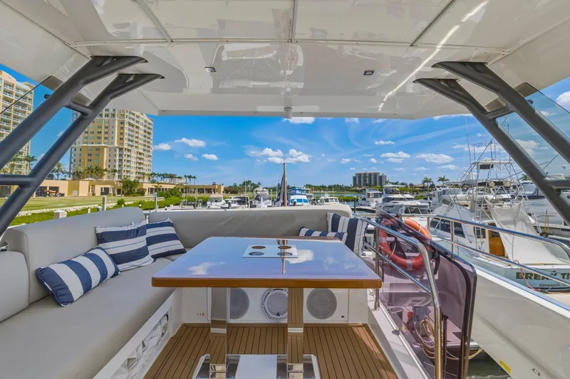 Slide: The Image of Luxurious 2022 Prestige 520 yacht interior with striped cushions, docked at a marina. - 30