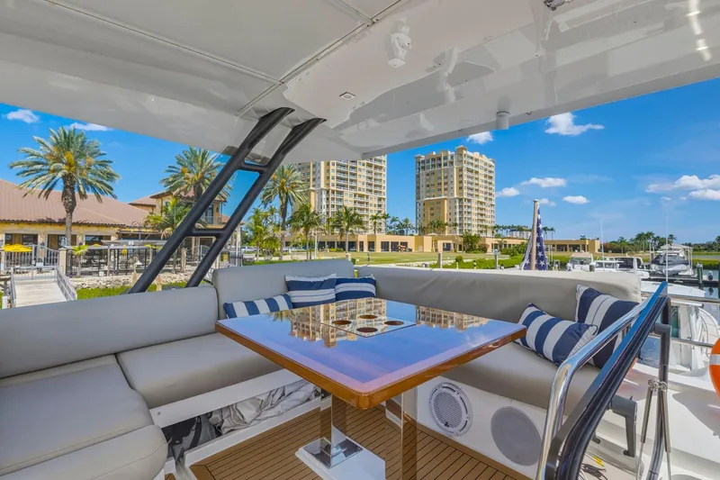 Slide: The Image of Luxurious 2022 Prestige 520 yacht interior with elegant seating and scenic marina view. - 31