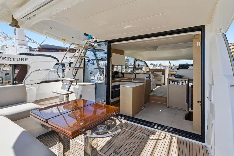 Slide: The Image of Luxurious 2022 Prestige 520 yacht interior with modern kitchen and seating area. - 4